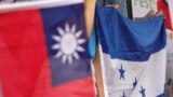 People hold Honduran and Taiwanese flags during a gathering at National Taiwan University in Taipei, Taiwan, in support of Honduras-Taiwan diplomatic relations, March 25, 2023. Honduras said on Saturday it was ending its decades-long ties to Taiwan.