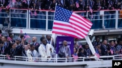 The boat carrying team United States, with Lebron James carrying the flag, makes its way down the Seine River in Paris, France, during the opening ceremony of the 2024 Summer Olympics, July 26, 2024.