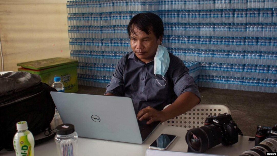 FILE - Myanmar photojournalist Sai Zaw Thaike is seen working in this undated photo. (Myanmar Now/Handout via Reuters)