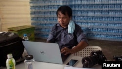 FILE - Myanmar photojournalist Sai Zaw Thaike is seen working in this undated photo. (Myanmar Now/Handout via Reuters)