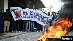 Indonesian protesters burn a tire during a protest for the deportation of the Rohingya refugees in Banda Aceh, Aceh province, Dec. 27, 2023. 