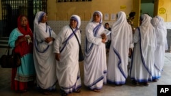 Nuns of the Missionaries of Charity, the order founded by Mother Teresa, stand in queue to cast their votes during the last round of a six-week-long national election, in Kolkata, India, June 1, 2024.