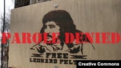 FILE - This photo taken March 28, 2009, shows a sign calling for the release of AIM activist Leonard Peltier. He was denied parole for the third time on July 2, 2024.