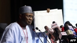 The chairman of Nigeria's Independent National Electoral Commission, Yakubu Mahmood, displays a results sheet to the media during the presentation of final results of the country's general and presidential election, in Abuja, Feb. 27, 2023.