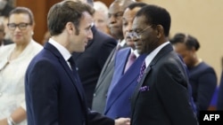 French President Emmanuel Macron, left, talks with Equatorial Guinea President Teodoro Obiang Nguema Mbasogo, right, during the One Forest Summit at the Presidential Palace in Libreville, March 2, 2023.