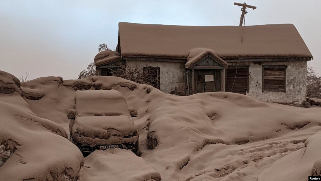 Sebuah rumah dan mobil tertutup debu vulkanik setelah erupsi gunung berapi Shiveluch di wilayah Kamchatka di Timur Jauh Rusia, 11 April 2023. (Institut Vulkanologi dan Seismologi/Handout via Reuters)