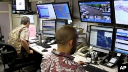 FILE - Hawaii Emergency Management Agency officials work at the department's command center in Honolulu on Dec. 1, 2017. 