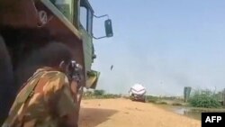 A grab from a UGC video posted on the X platform (formerly Twitter) on Aug. 22, 2023, reportedly shows members of the Sudanese army firing at Rapid Support Forces fighters in what they say is the al-Shajara military base in Khartoum. (Photo by UGC / AFP)
