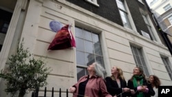 Officials unveil the plaque number 1,000 to honor the Women's Freedom League, a suffragist organization that used 1 Robert Street in central London as its base of operations during its most active period, Sept. 19, 2023. 