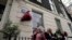 Officials unveil the plaque number 1,000 to honor the Women's Freedom League, a suffragist organization that used 1 Robert Street in central London as its base of operations during its most active period, Sept. 19, 2023. 