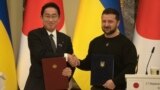 Japanese Prime Minister Fumio Kishida, left, and Ukrainian President Volodymyr Zelenskyy, greet each other after the signing of joint documents in Kyiv, Ukraine, March 21, 2023.