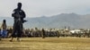 FILE - Taliban security personnel stand guard as people watch a public flogging at a stadium in Charikar, Parwan province, Afghanistan, Dec. 8, 2022. A similar public flogging was conducted on June 4, 2024, in Sar-e Pul, capital of an Afghan province of the same name.