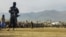 FILE - Taliban security personnel stand guard as people watch a public flogging at a stadium in Charikar, Parwan province, Afghanistan, on Dec. 8, 2022. Four people, including a woman, were similarly flogged recently, Taliban officials said on Oct. 29, 2024.