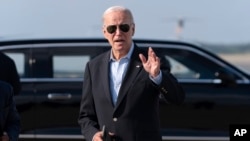 President Joe Biden talks to reporters upon his arrival to Joint Base Andrews, Md., en route to the White House, Aug. 18, 2024. 