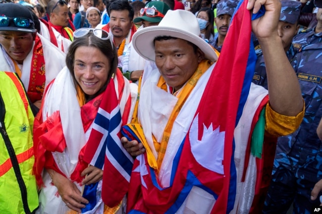 FILE - Norwegian climber Kristin Harila, left, and her Nepali sherpa guide Tenjen Sherpa, right, who climbed the world's 14 tallest mountains in record time, arrive in Kathmandu, Nepal, Aug. 5, 2023. (AP Photo/Niranjan Shrestha, File)