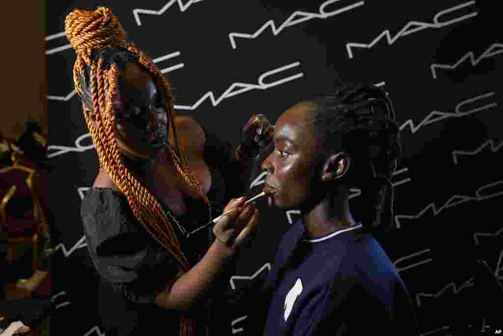 A model does makeup backstage before the ARISE Fashion Week event in Lagos, Nigeria Friday, February 3, 2023.