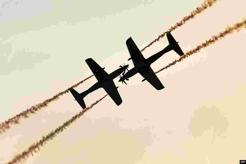 Two planes of the Royal Australian Air Force Roulettes aerobatic team perform during the Australian International Airshow Aerospace and Defence Expo at Avalon Airport in Geelong.