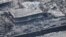 Wildfire wreckage is shown Aug. 10, 2023, in Lahaina, Hawaii. Residents crossed the wall into the ocean to escape the fire that was moving through the community.