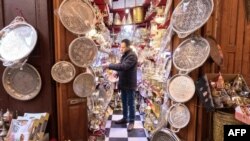 FILE - Screen grab of Abdelilah Mounir, craftsman selling copper objects in his store in Fes, Morocco on December 13, 2023