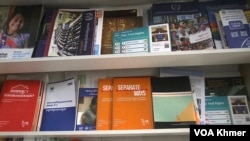 A report titled “Separate Ways” is placed among other reports on a shelf in the office of Klahaan Organization in Phnom Penh City on April 11, 2024. (Ser Davy/ VOA Khmer)