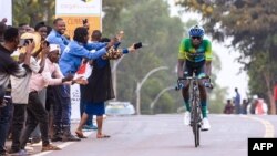 FILE: Cycling spectators cheer on as Jean Bosco Nsengimana (R) rides in a solo breakaway during stage 3 of the Tour du Rwanda from Huye to Musanze. Taken Feb. 21, 2023. 