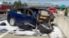 FILE - In this March 23, 2018, photo provided by KTVU, emergency personnel work at the scene where a Tesla electric SUV crashed into a barrier on U.S. Highway 101 in Mountain View, Calif. The crash killed an Apple engineer.