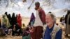 FILE - World Food Program chief David Beasley meets with villagers in the village of Wagalla in northern Kenya, Aug. 19, 2022.