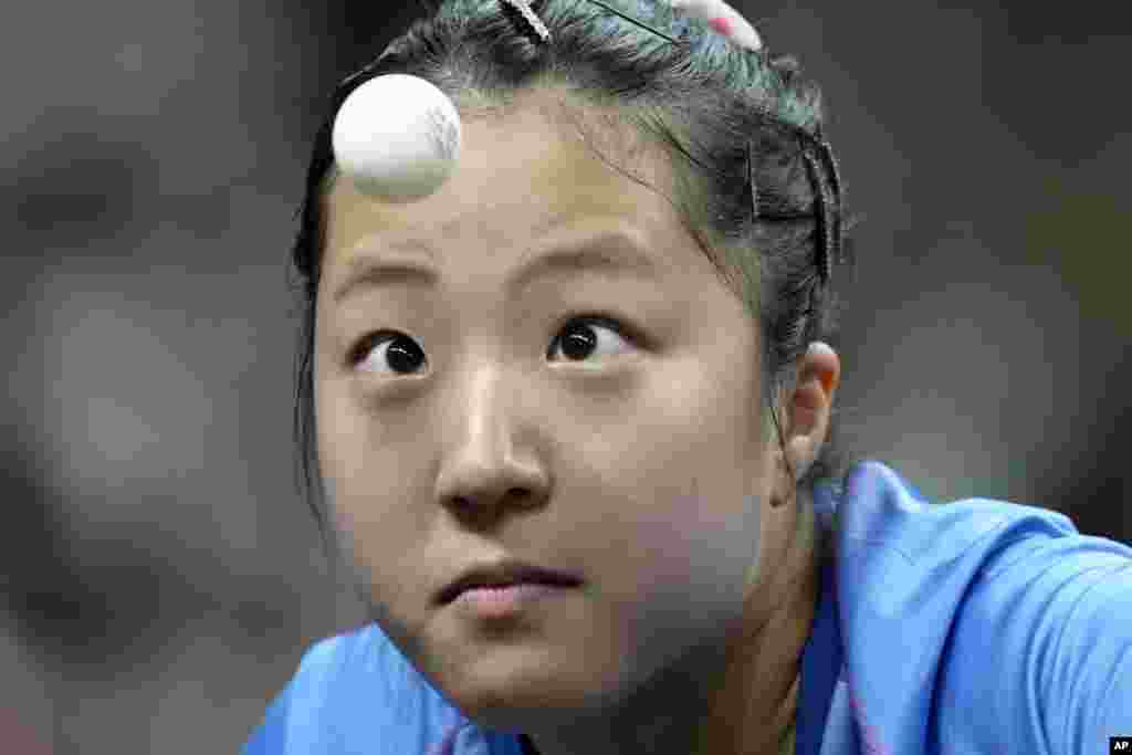 South Korea&#39;s Shin Yubin watches the ball during a mixed doubles semifinal table tennis game against China&#39;s Wang Chuqin and Sun Yingsha, at the 2024 Summer Olympics in Paris, France.