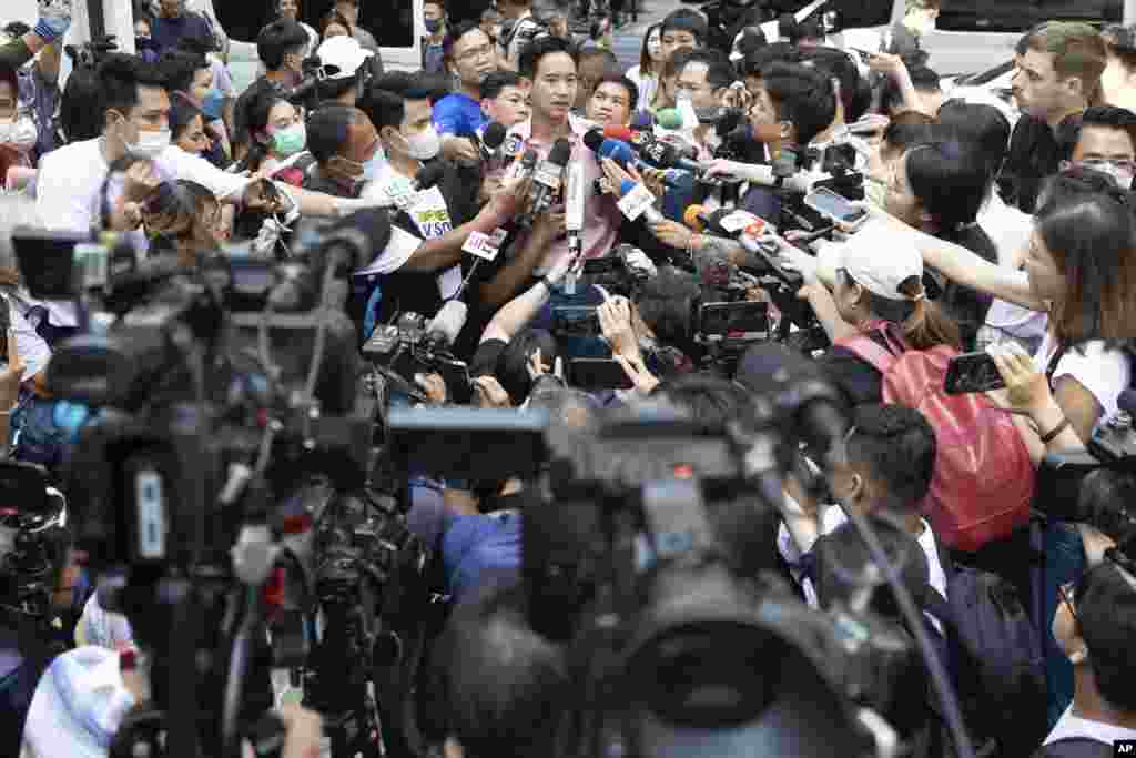 Leader of Move Forward Party Pita Limjaroenrat, rear center, talks to media after casting his vote during a general election at a polling station in Bangkok, Thailand.