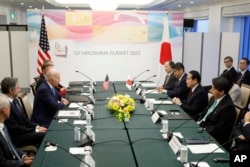President Joe Biden, center, sits with Secretary of State Antony Blinken, second left, during a bilateral meeting with Japan's Prime Minister Fumio Kishida, opposite, in Hiroshima, May 18, 2023, ahead of the start of the G-7 Summit.