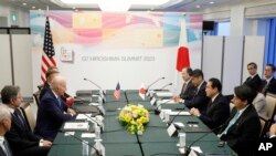 President Joe Biden, center, sits with Secretary of State Antony Blinken, second left, during a bilateral meeting with Japan's Prime Minister Fumio Kishida, opposite, in Hiroshima, May 18, 2023, ahead of the start of the G-7 Summit. 