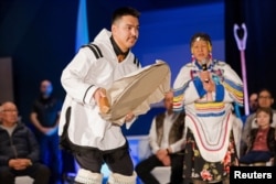 A drummer dances during the Nunavut devolution agreement ceremony at the Aqsarniit Hotel & Conference Centre in Iqaluit, Nunavut, Canada, Jan. 18, 2024.