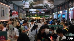FILE - Visitors attend the 33rd Hong Kong Book Fair in the Wan Chai area of Hong Kong on July 19, 2023.