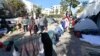 Sub-Saharan African migrants camp outside the headquarters of the International Organization for Migration in Tunis, Tunisia, March 2, 2023.