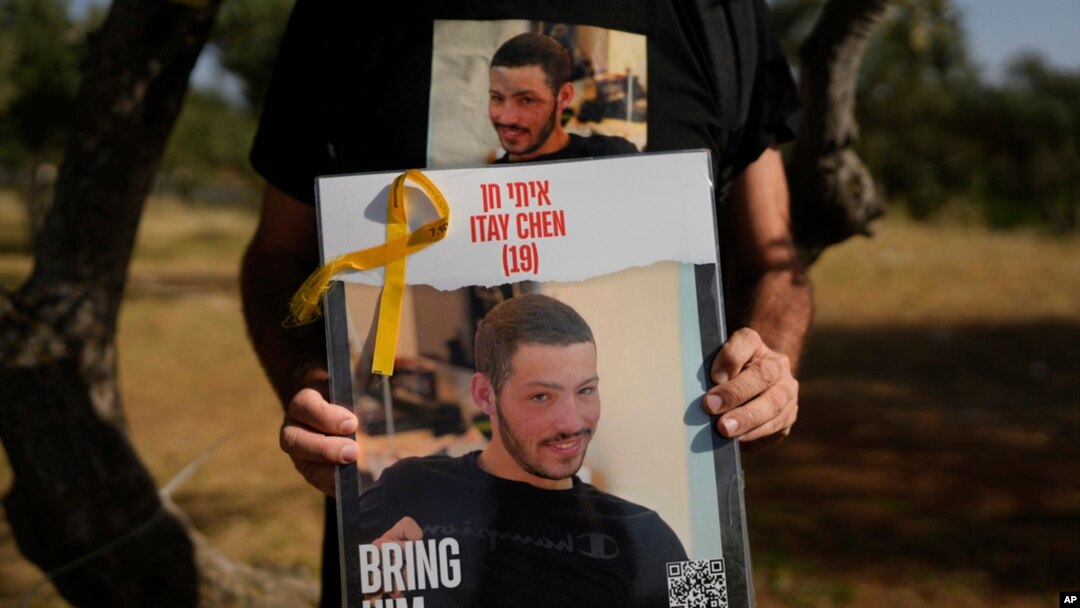 Ruby Chen holds a poster of his son, Itay Chen, during a protest near Israel's parliament in Jerusalem, March 9, 2024.
