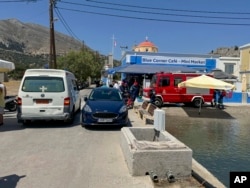 A view of an ambulance and a fire brigade van are on a beachfront of Symi island, Greece, June 9, 2024.