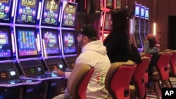 FILE - Gamblers play slot machines at the Hard Rock Casino in Atlantic City, N.J., on May 17, 2023. 