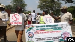 FILE - Zimbabweans protest against sanctions imposed on their leaders outside the U.S. Embassy in Harare in October 2022. It may soon be a crime if any Zimbabwean attends a meeting calling for sanctions against the nation. (Columbus Mavhunga/VOA)