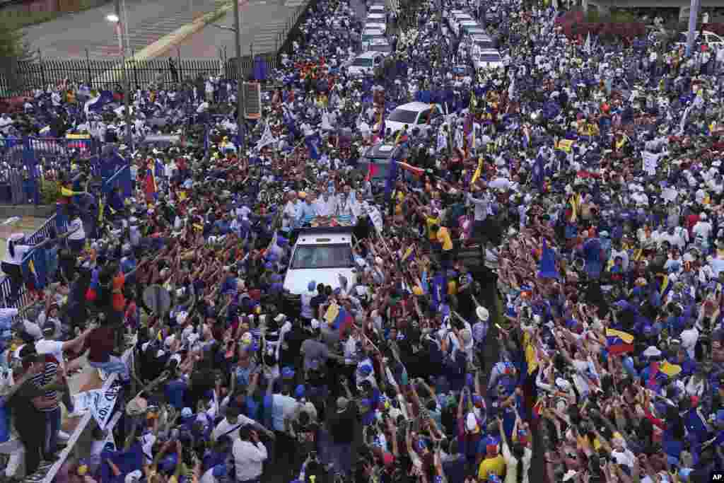 Presidential candidate Edmundo Gonzalez, center, and opposition leader Maria Corina Machado, center right, greet supporters during a campaign rally in Maracaibo, Venezuela, July 23, 2024. 