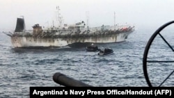FILE - Handout picture released by Argentina's Navy Press Office showing the ARA "Bouchard" Ocean Patrol escorting a Chinese flag fishing ship after it was caught illegally operating in Argentina's Exclusive Economic Zone, May 4, 2020. 