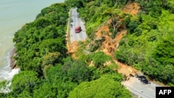 This handout picture released by Ubatuba Civil Defense shows the SP-55 highway blocked by a landslide in the municipality of Ubatuba, north coast of the state of Sao Paulo, Brazil on Feb. 19, 2023. (Photo by Ubatuba Civil Defense / AFP)