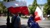 People wait for a march organized by main opposition party the Civic Platform (PO) on the 34th anniversary of the first democratic elections in postwar Poland, in Warsaw, June 4, 2023. 