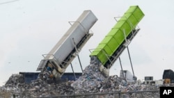 FILE - Garbage is loaded into a landfill in Lenox Township, Mich., July 28, 2022. A new United Nations report estimates that 19% of the food produced around the world went to waste in 2022. 