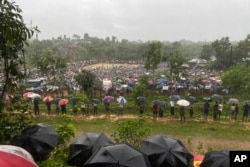 Hundreds of Rohingyas gather in the rain to demand safe return to Myanmar's Rakhine state as they mark the seventh anniversary of their exile from Myanmar at their refugee camp at Kutupalong in Cox's Bazar district, Bangladesh, Aug. 25, 2024.