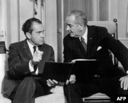 FILE - President-elect Richard Nixon and President Lyndon B. Johnson confer on the orderly transition of power in the chief executive's White House office, Dec. 12, 1968, in Washington. Richard Nixon become the 37th president of the United States.