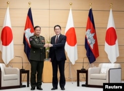 FILE - Lt.Gen. Hun Manet, Commander of the Royal Cambodian Army meets Japan's Prime Minister Fumio Kishida during his visit to Japan at the Prime Minister's official residence in Tokyo, Japan, February 16, 2022.