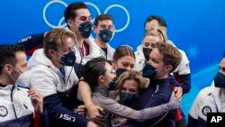 FILE - Madison Chock and Evan Bates, of the United States, reacts after the team ice dance program during the figure skating competition at the 2022 Winter Olympics, Feb. 7, 2022, in Beijing.