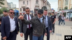This videograb made on July 1, 2024 shows France's President Emmanuel Macron (C) walking on June 29, 2024 in a street in Le Touquet-Paris-Plage, northern France.
