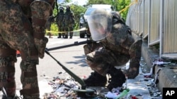 South Korean soldiers wearing protective gear check the trash from a balloon presumably sent by North Korea, in Incheon, South Korea, June 2, 2024. 