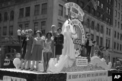 File - Members of the International Ladies' Garment Workers' Union are seen on a Labor Day parade float, Sept. 4, 1961.